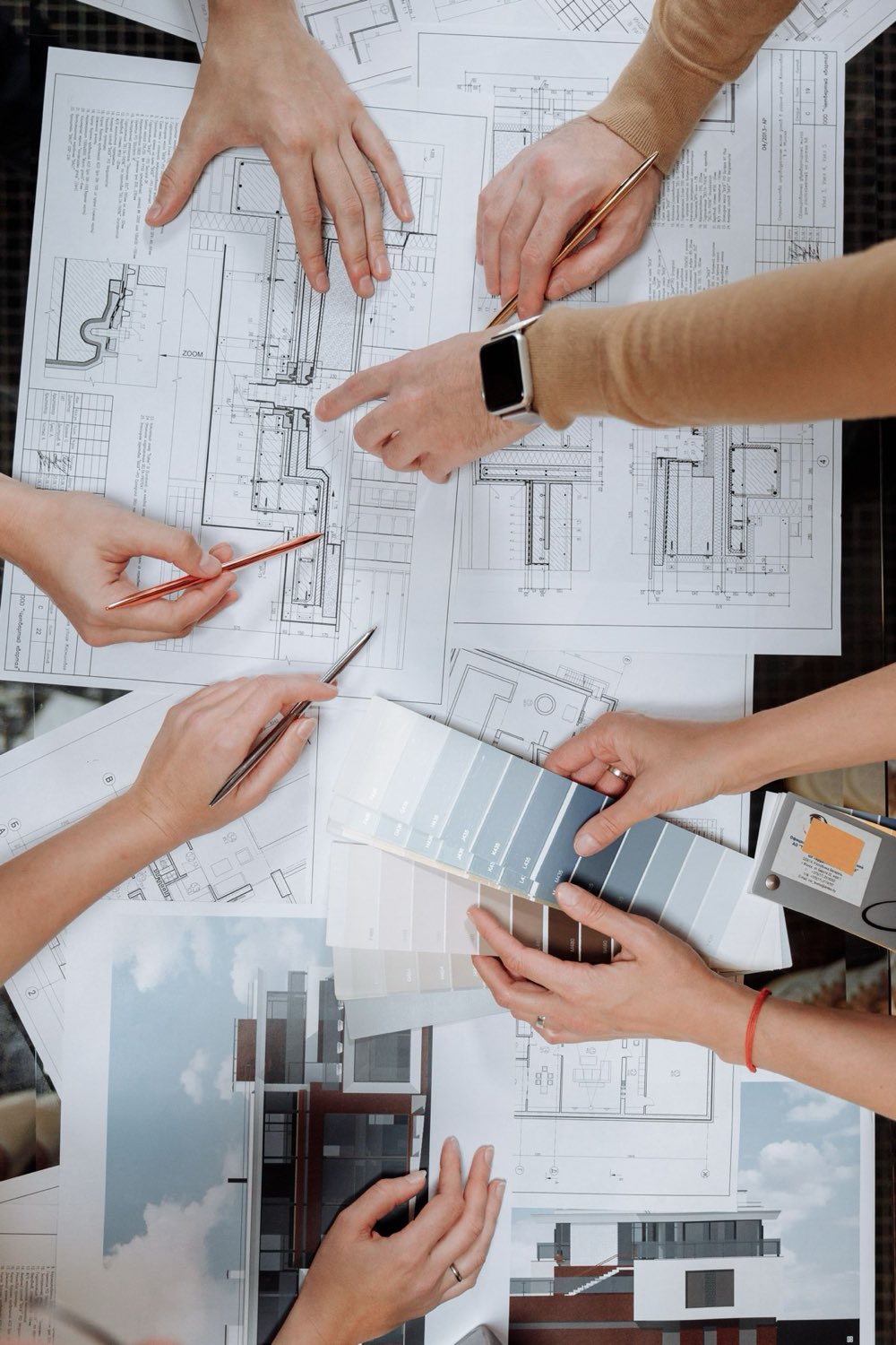Plans and material samples laid out on a table