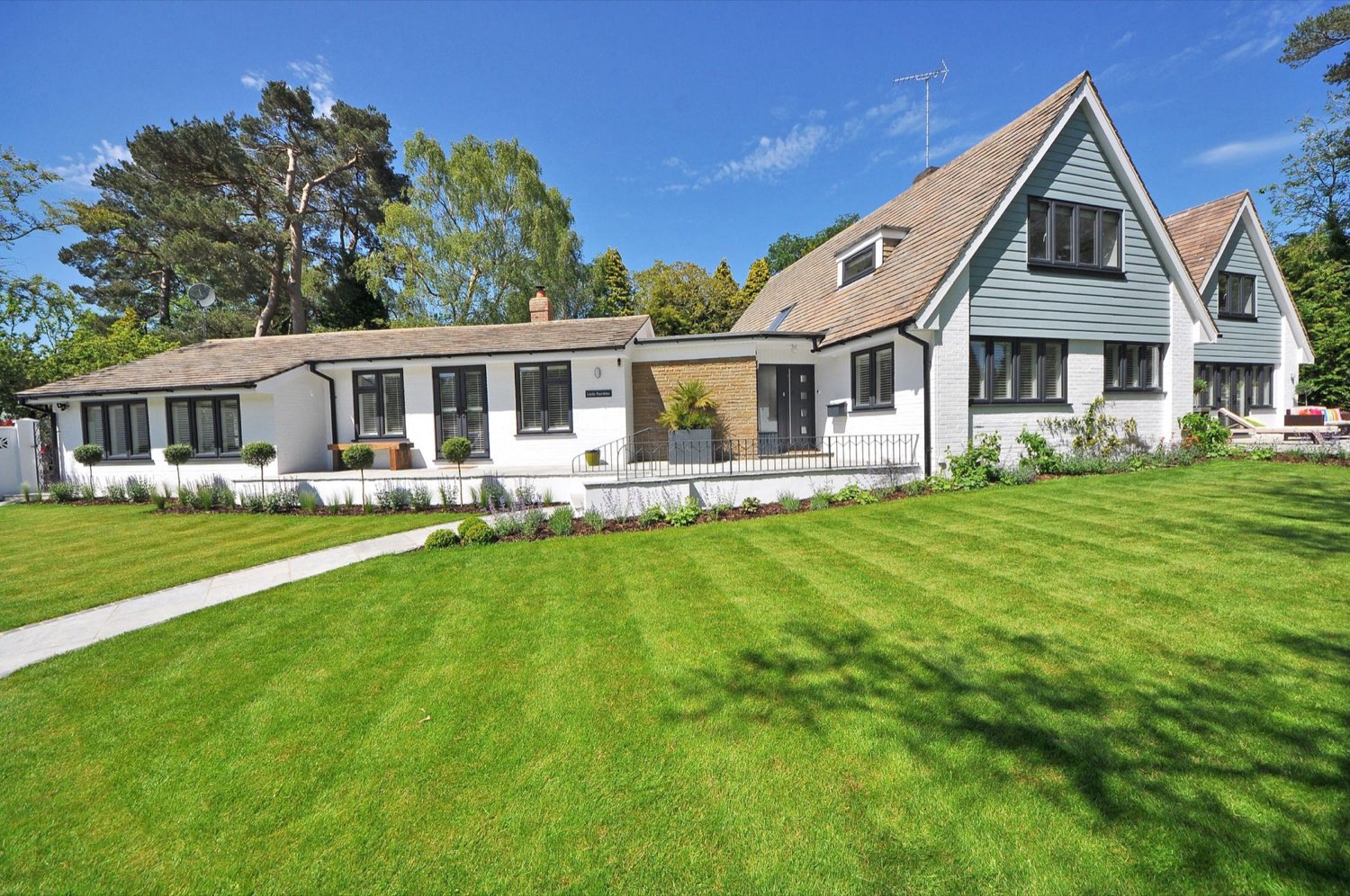 A white rendered house with a single-storey rear extension across the back elevation