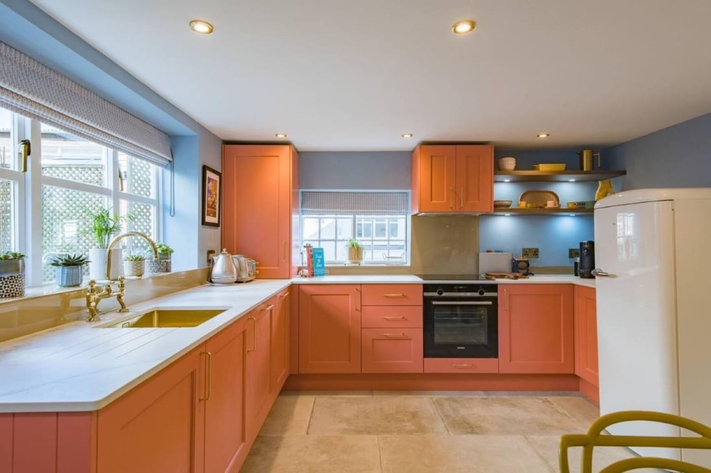 A shaker kitchen in burnt orange, fitted wall to wall